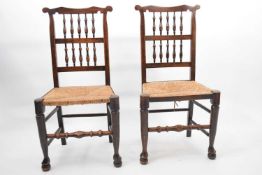 Pair of North Country spindle back and rush seated dining chairs with turned front rails, 99cm high