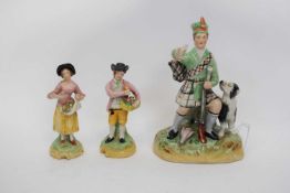 Group of Staffordshire wares including a Scotsman with dog, and two smaller figures of fruit sellers