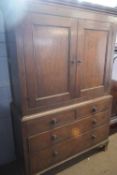 Georgian oak former linen press cabinet, with moulded cornice over two panelled doors opening to a