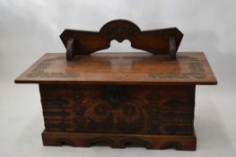 Scandinavian oak coffer with carved detail and heavy metal strapping and hinge, top fitted with a