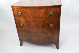 Late Georgian mahogany bow front chest of three drawers raised on slightly spade legs, 92cm wide