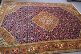 20th century fine Bijar wool floor rug decorated with large central blue panel surrounded by a