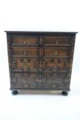 Early 20th century Jacobean style oak chest of two short over three long drawers decorated with