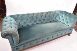 Late 19th century Chesterfield style sofa upholstered in a turquoise buttoned fabric, raised on