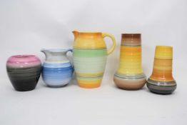 Group of Shelley wares with typical ribbed coloured designs comprising two jugs and two vases and