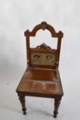 Victorian aesthetic style light oak hall chair, inset with two Shakespeare tiles, raised on tapering