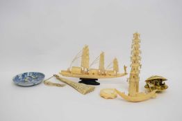 Group of ivories, Meiji period, including two models of a Chinese junk, a carved ivory fan and shell