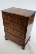 Reproduction William and Mary style walnut chest of three short and three long drawers raised on