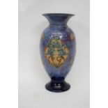 A Royal Doulton vase the mottled blue ground with shaped panels containing tube lined floral sprays