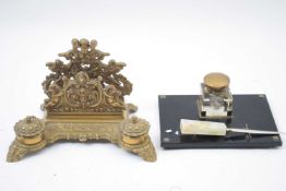 Cast brass desk stand of decorative form fitted with two inkwells, together with a further ink