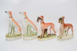 Pair of Staffordshire greyhounds with rabbits and further pair seated on their haunches (4)