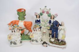 Group of Stafforeshire wares including a model of a cow and heifer, and group of gentleman and