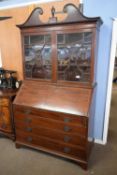 Large George II mahogany bureau bookcase with broken arch pediment over dentil carving and two