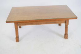 20th century solid oak coffee table of rectangular form raised on turned legs with glass cover, 52cm
