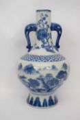 Modern Chinese porcelain vase with blue and white design of mountains within Ming style borders