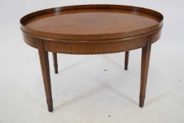 Reproduction oval mahogany occasional table with galleried rim, raised on tapering legs, 72cm wide