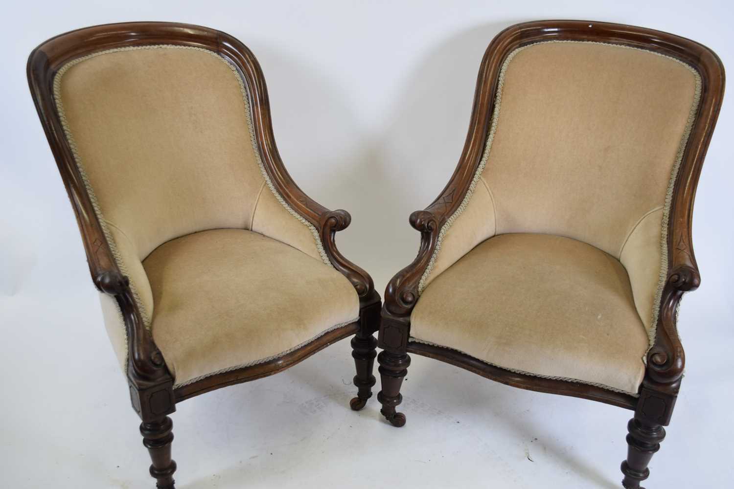 Near pair of Victorian mahogany framed armchairs upholstered in mushroom fabric raised on turned