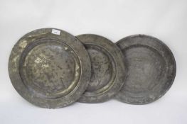 Three 18th century pewter circular plates or chargers, of plain form, 38cm diam