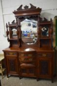 IMPRESSIVE BOW FRONT MAHOGANY SIDE CABINET WITH MIRRORED BACK, HEAVILY CARVED DETAIL THROUGHOUT,