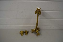 GILT METAL CANDLESTICK, THE BASE FORMED AS THREE LIONS, TOGETHER WITH TWO GILT METAL RAMS HEAD