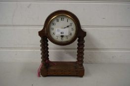 SMALL EARLY 20TH CENTURY OAK CASED MANTEL CLOCK ON BARLEY TWIST SUPPORTS