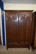 EARLY 20TH CENTURY OAK WARDROBE WITH TWO PANELLED DOORS OVER A SINGLE DRAWER BASE, 191CM HIGH