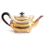 George V silver cushion shaped tea pot with gadrooned rim, supported on four cast feet, height 10.
