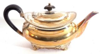 George V silver cushion shaped tea pot with gadrooned rim, supported on four cast feet, height 10.