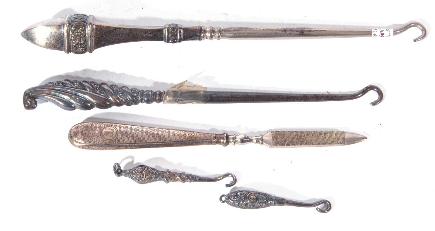 Mixed Lot comprising two silver mounted glove hooks and two silver mounted boot hooks plus a further