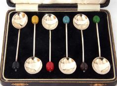 Cased set of six George V coffee spoons with oval bowls and harlequin bean ends, Birmingham