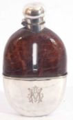 Large silver plated hip flask, the upper portion of the glass flask ornamented in leather, with