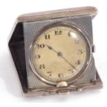 Antique 925 marked travel clock in engine turned folding case, the inside of the case with