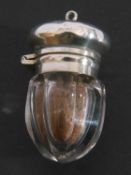 Antique glass vinaigrette scent bottle, the clear glass acorn shaped body with white metal hinged