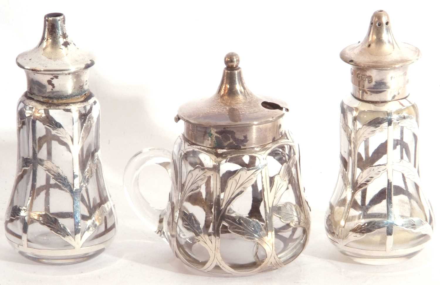 Cased matched three piece glass and silver overlaid condiments, comprising hinged mustard, Chester