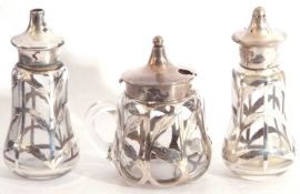 Cased matched three piece glass and silver overlaid condiments, comprising hinged mustard, Chester