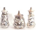 Cased matched three piece glass and silver overlaid condiments, comprising hinged mustard, Chester