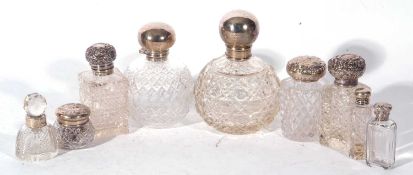 Collection of nine various cut clear glass and silver topped dressing table jars and bottles, late