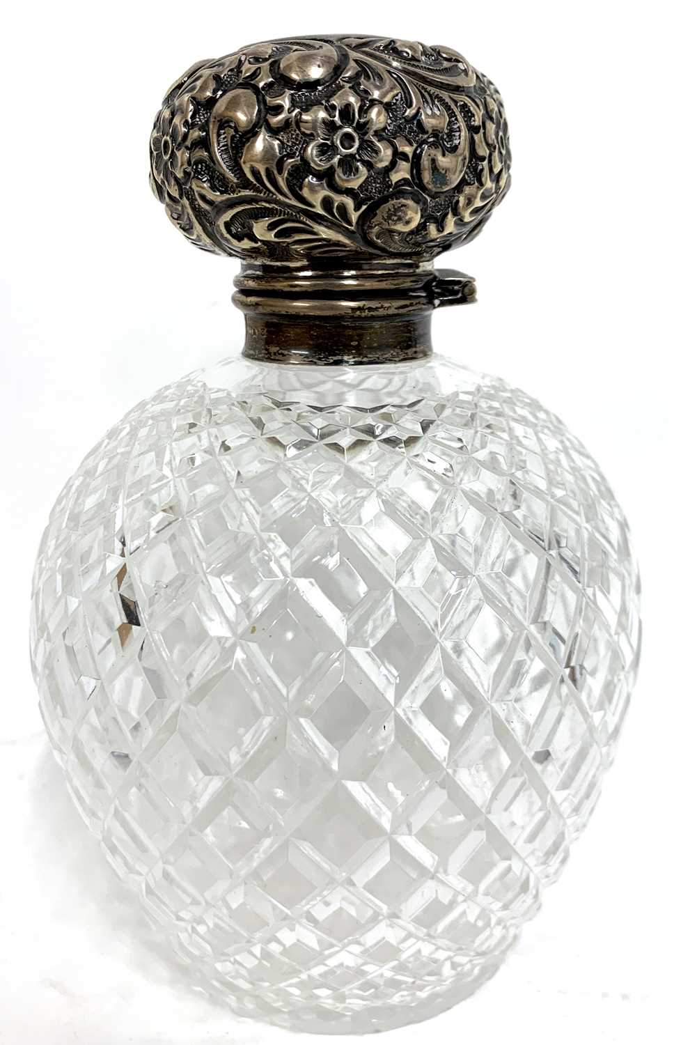 Edward VII spherical faceted cut glass scent bottle with hinged embossed silver lid, complete with