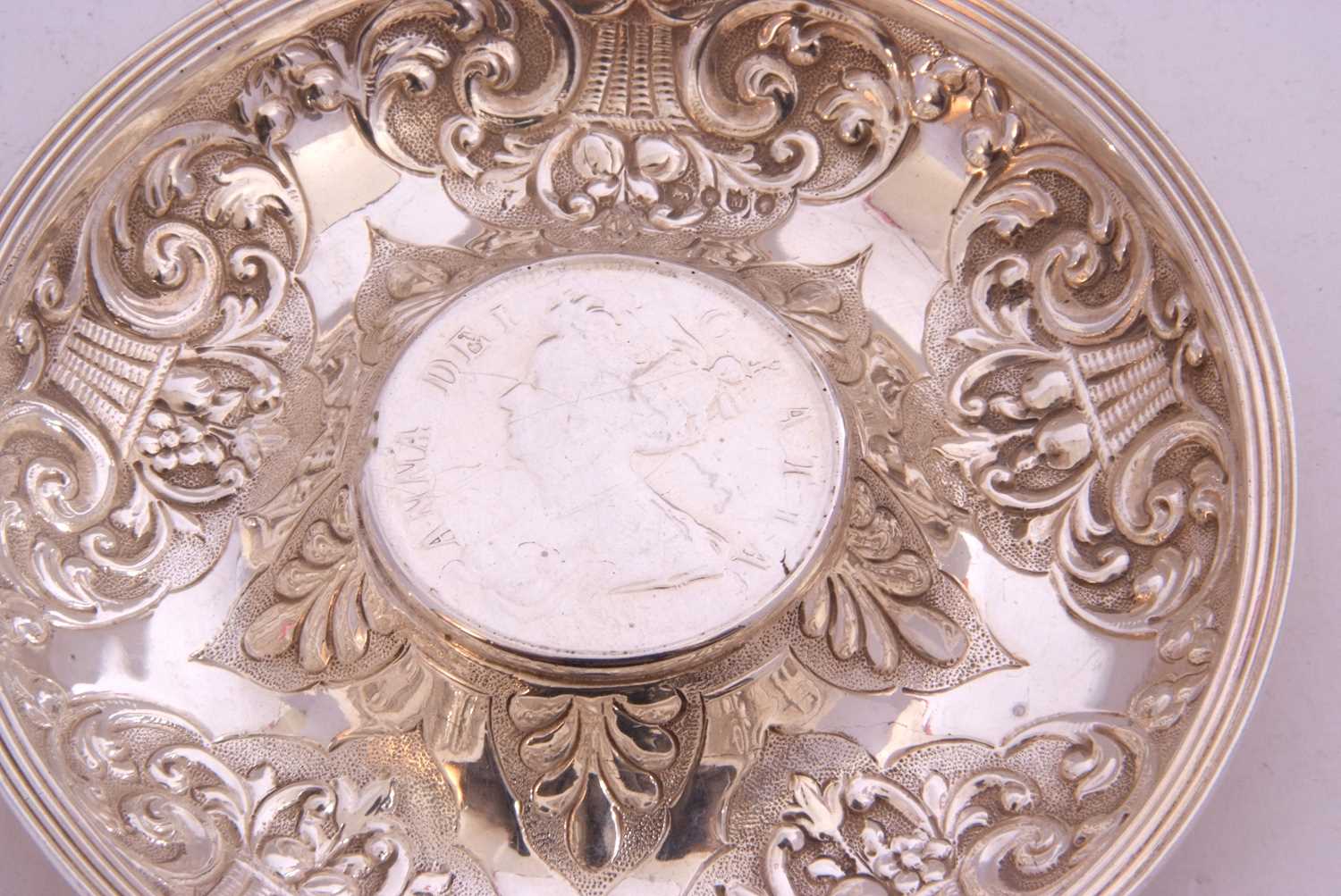 White metal dish of circular form, embossed with baskets of flowers, the centre raised with a 1707 - Image 4 of 5