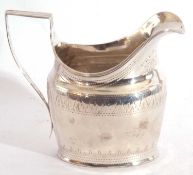 George III cream jug of helmet shape, the body embellished with bands of prick work engraved