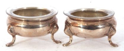Large pair of Georgian silver open salts, each supported on three hoof feet, having clear glass