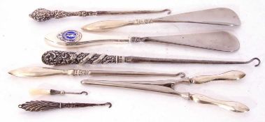 Mixed Lot: three silver long handled button hooks, two silver handled shoe horns, one enamelled with