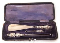 Late Victorian three piece set of two silver handled button hooks and shoe horn with steel blades (