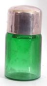Antique green glass smelling salts bottle of cylindrical form with screw on silver lid, hallmarked