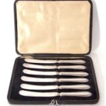 Cased set of six George V silver handled cake knives with zig-zag decoration to handles, plated