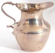 Victorian silver small cream jug, the plain body with wavy rim and border, and a shaped handle,