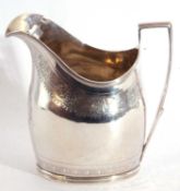 George III silver cream jug of helmet shape, features a reeded top rim, angular handle, the body