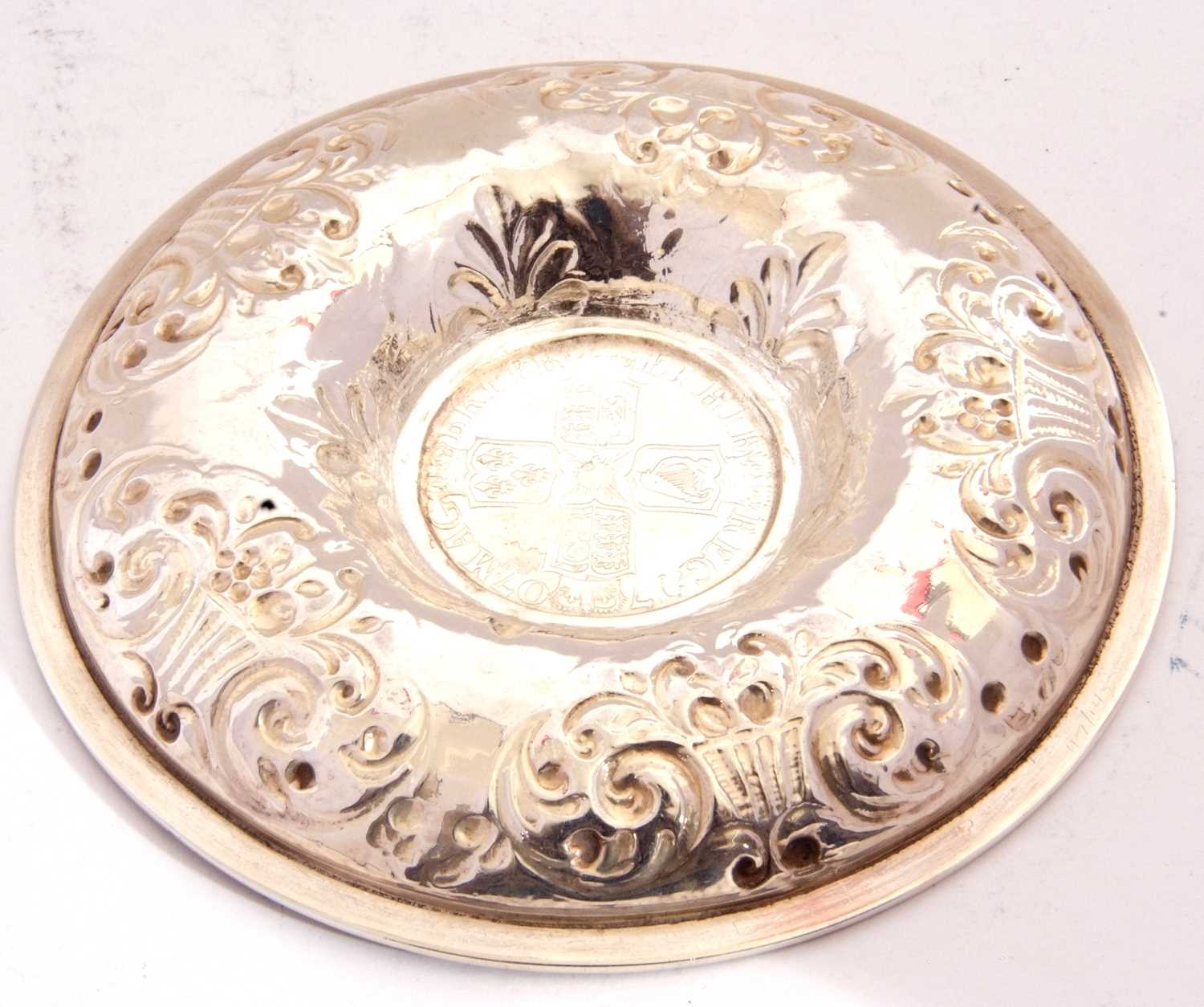 White metal dish of circular form, embossed with baskets of flowers, the centre raised with a 1707 - Image 3 of 5