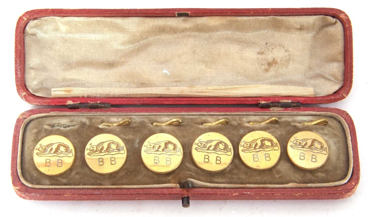 Cased set of six antique brass dress buttons, each engraved with a rabbit and initialled with the
