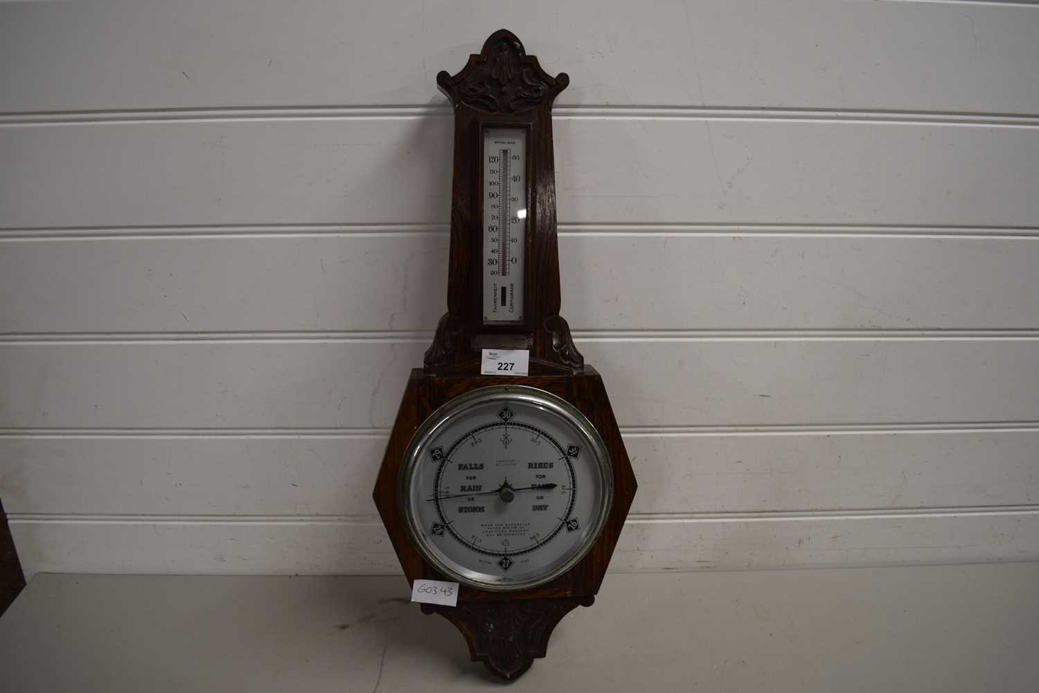 EARLY 20TH CENTURY OAK CASED BAROMETER AND THERMOMETER COMBINATION BEARING RETAILERS MARK FOR HARVEY